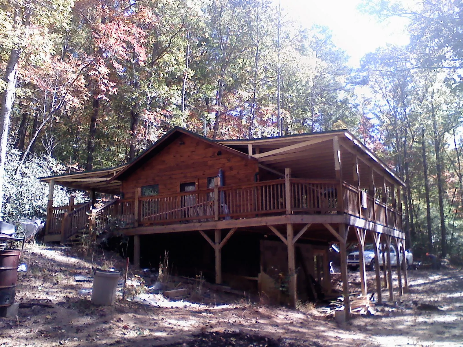 Log cabin with a wraparound porch and metal roof in the fall in Bruneau
